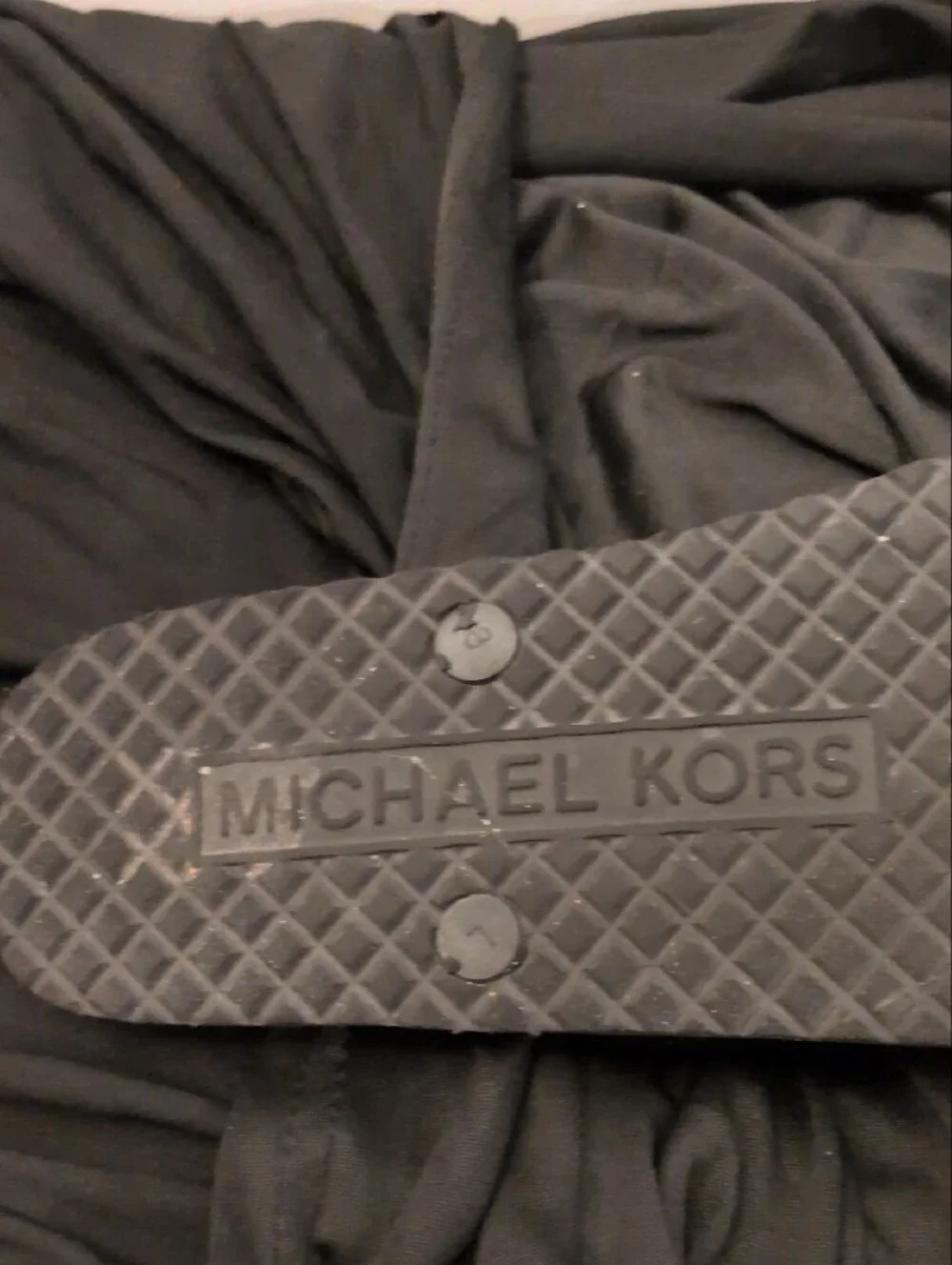 Michael Kors Black Logo Monogram Flip Flops with Silver MK Medallions.